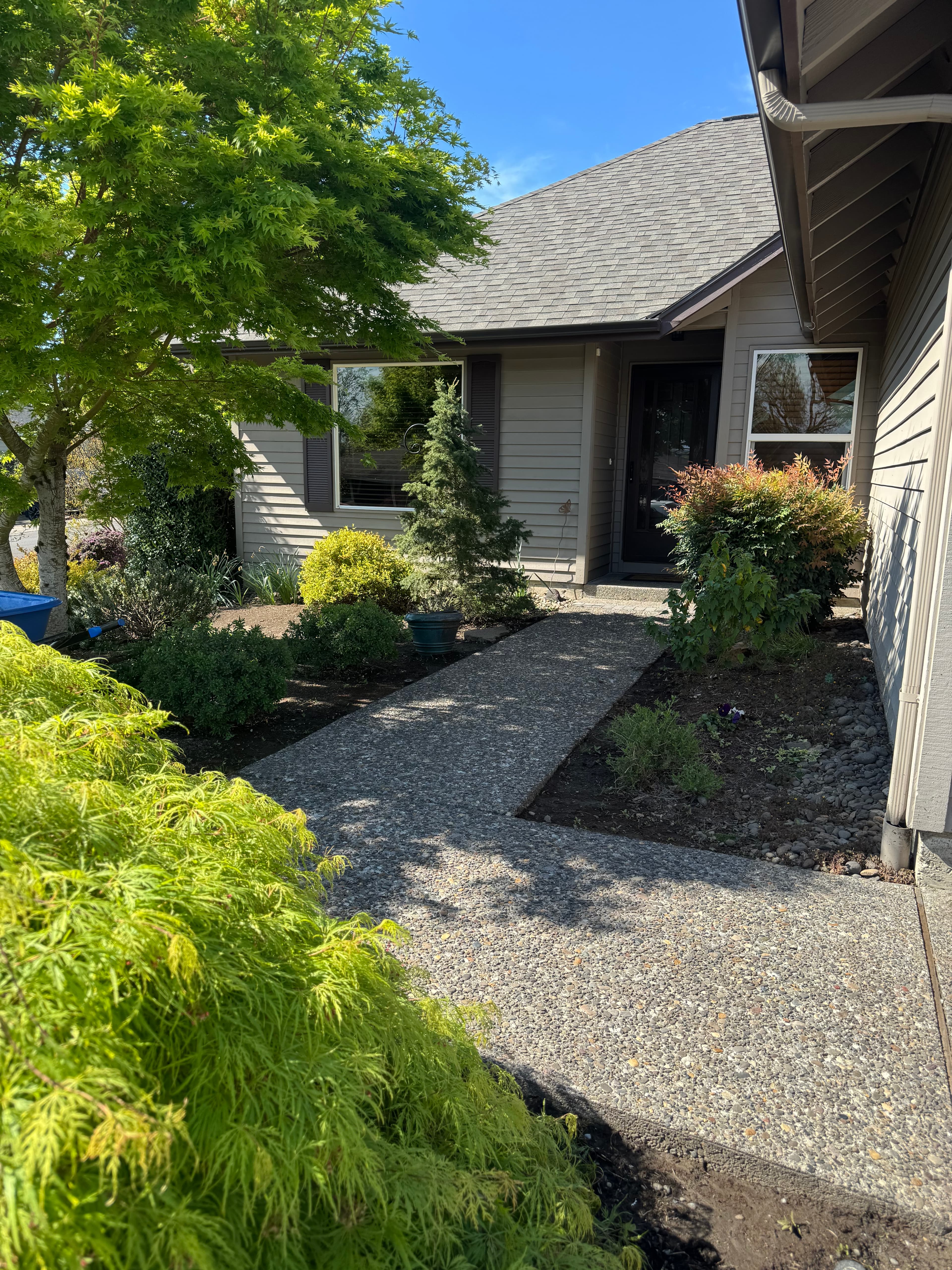 Clean Oregon City home exterior with fresh walkway and landscaping.